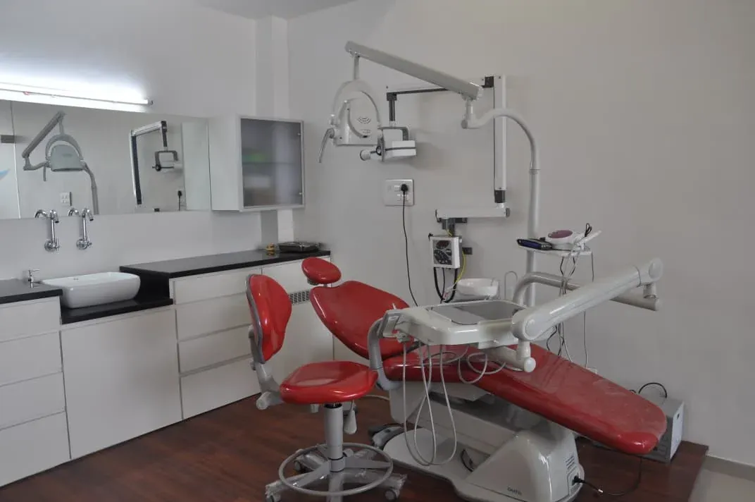 Dental Planet treatment room with a modern dental chair, overhead light and organised instrument cabinets